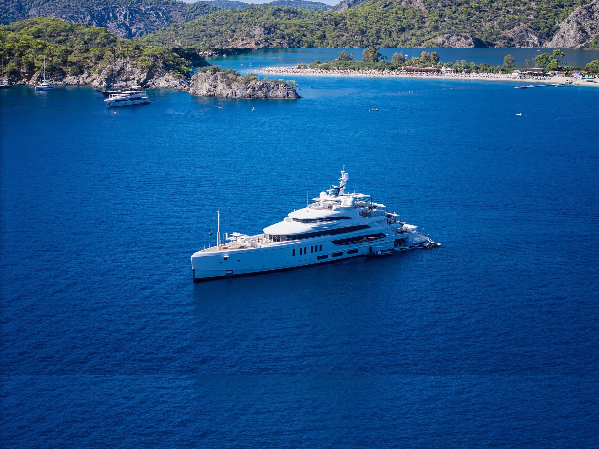 A luxury superyacht at anchor in a turquoise bay near Fethiye