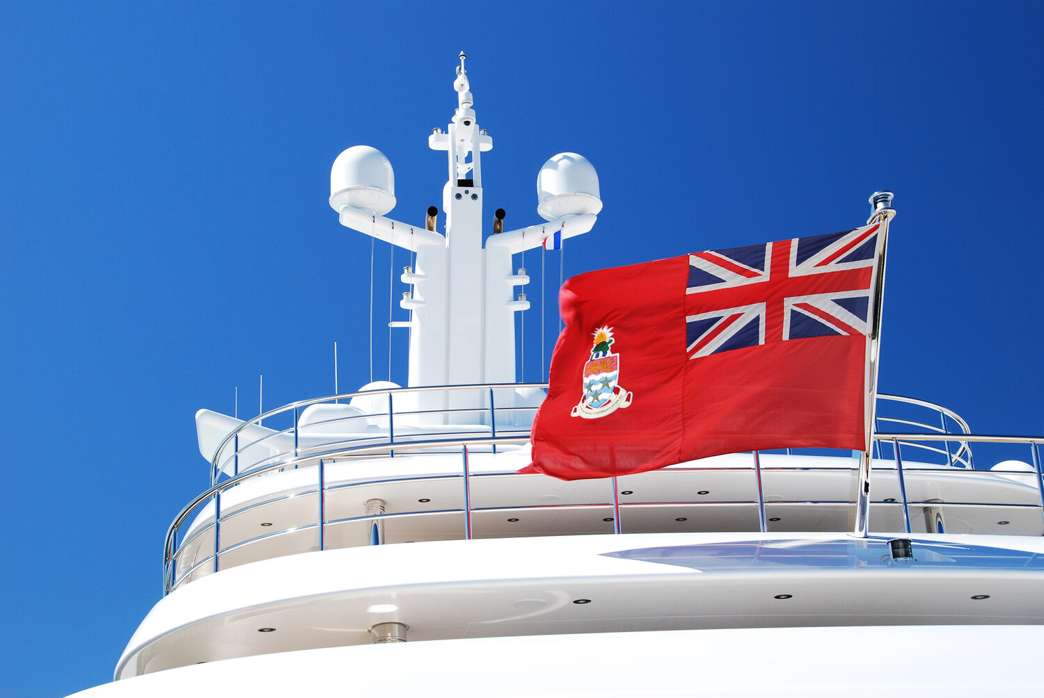 The British red ensign flying from the stern of a yacht